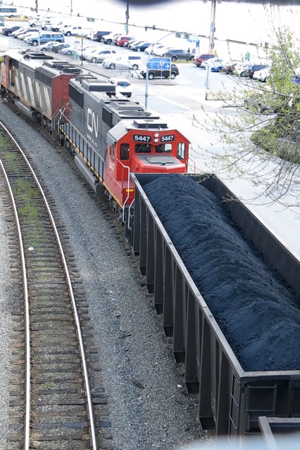 Open coal containers passing NW Pier Park and Mews